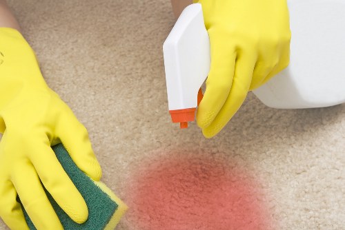 Commercial cleaner in Shoreditch cleaning an office workspace